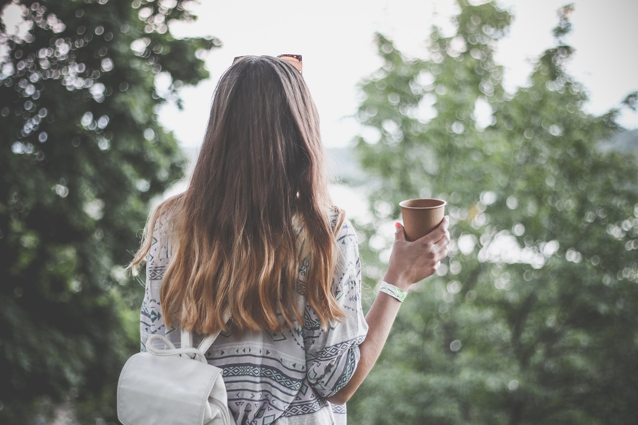 旅行にいくコーヒーを持った女性